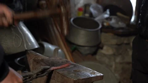 2/10 Blacksmith Forging Hits Metal Iron with Hummer In Workshop Stock Footage 233995395