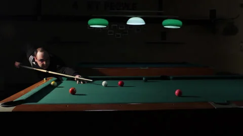 21/35 Man playing billiard. Player is taking a shot and put ball in the hole. Stock Footage 36431053