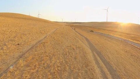 2.140 Fairfield Windmills Flying Forward Low Along Road with Windmills in the Stock-Footage 90257752