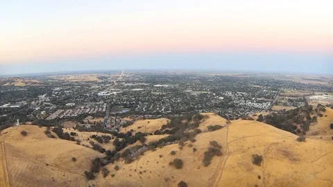 2.146 Vacaville Flying Forward Over Hill Towards Vacaville 000700 Stock Footage 90257666