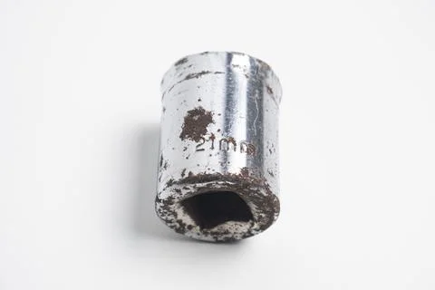 A 21mm socket made of chrome-plated steel, showing signs of wear and rust. .. Stock Photos
