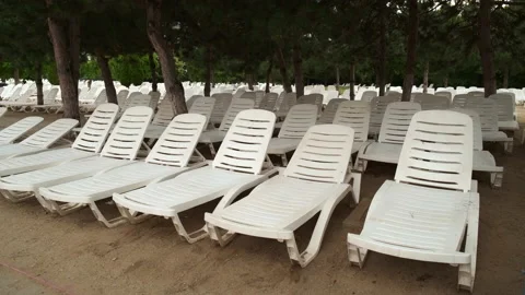22-07-09 1 empty white beach chairs handheld Stock Footage 230150174