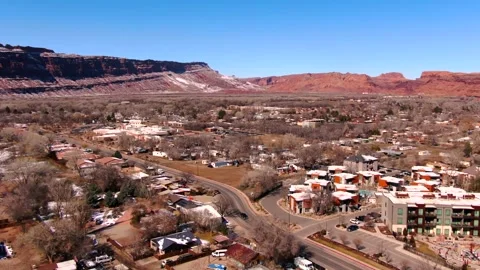 22 second long aerial flight over downtown Moab Utah during the wintertime. Video stock 329544854