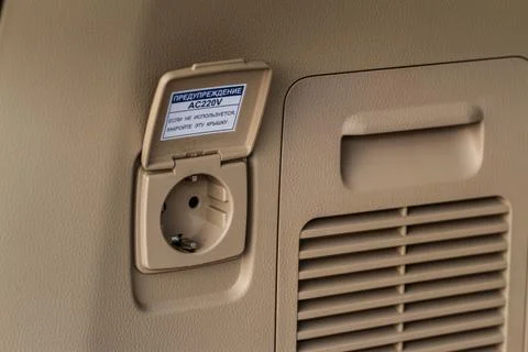 220v power outlet socket in the car. Opened sockets. Stock Photos