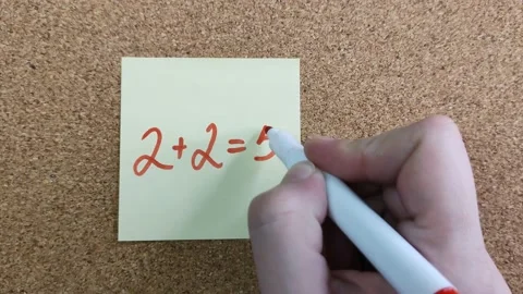 2+2=5.  A simple mathematical equation on a yellow sticker 스톡 동영상 170550444