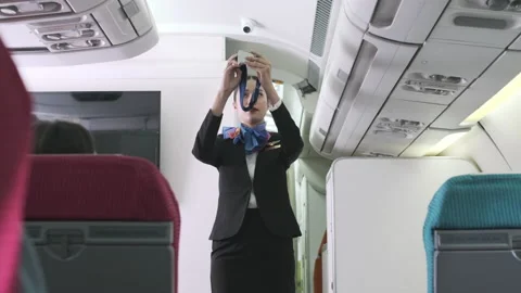 2261 Cabin crew demonstrate how to fasten seat belt Stock Footage 144328831