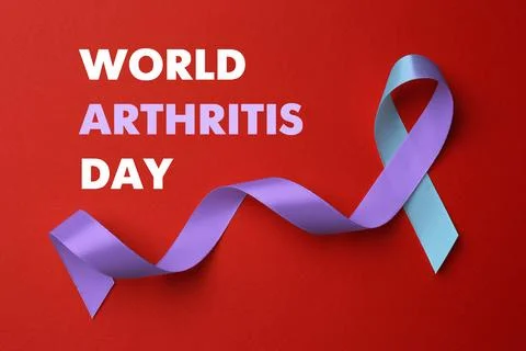 World Arthritis Day. Blue and purple awareness ribbon on red background, top view xkwx arthritis,awareness,background,blue,body,bone,care,concept,day,design,disease,flat,health,help,human,illness,inflammation,international,joint,knee,lay,medical,medicine,month,object,october,osteoporosis,pain,prevention,problem,purple,red,rheumatism,rheumatoid,ribbon,satin,sign,silk,support,symbol,top,view,violet,wad,world