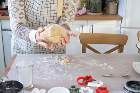 Hands  knead  thick  dough  on  the  kitchen  table,  decorated  with  festive  decorations  for  Christmas  and  New  year.  Baking  at  home,  aroma  and  comfort.  Close-up xkwx knead,  thick,  dough,  kitchen,  table,  christmas,  flour,  new  year,  baking,  molds,  cookies,  snowman,  home,  aroma,  comfort,  hands,  housewife,  bakery,  wheat,  bread,  mood,  cozy,  interior,  decor,  preparing,  sculpt,  woman,  cook,  homemade,  dessert,  cutting,  form,  prepare,  making,  shape,  raw,  baker,  recipe,  kneading,  cooking,  pastry,  sweet,  winter,  holiday,  cookie,  bake,  eating,  hand,  cuisine