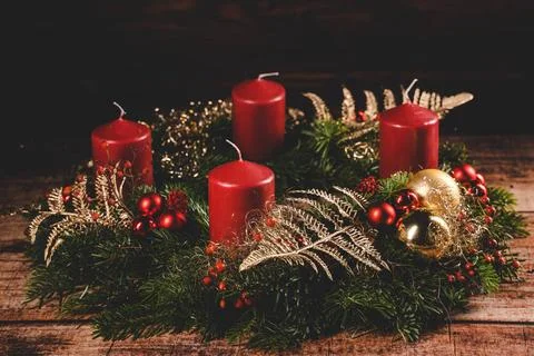 23 October 2022: red Advent wreath with four red candles. Symbol of Christ... Stock Photos