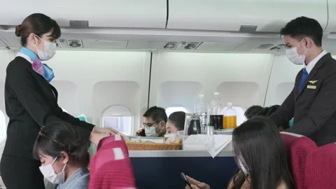 2302 Cabin crew move trolley and pass through passenger Video stock 144326652