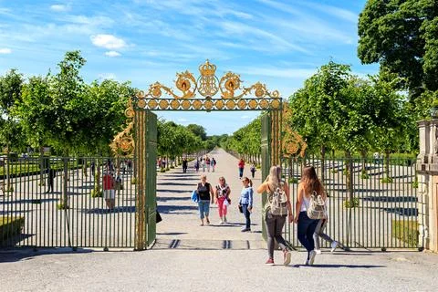 Stockholm, Sweden - June 23, 2019: Drottningholm Palace Garden, Monogram Entrance Arch, North gate xkwx palace,sweden,tourism,garden,landmark,park,building,stockholm,drottningholm,architecture,travel,scandinavia,historic,royal,attraction,sky,drottningholm palace,swedish,old,heritage,summer,castle,residence,style,culture,facade,baroque,outdoor,statue,tourist,europe,famous,blue,green,sculpture,family,nordic,unesco,king,history,scenery,house,drottningholms slott,lawn,wealth,historical,tree,seat,luxury