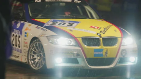 24 hour Car Racing at Night in Rain - Slow Motion - Racing Track and Pit Stop Stock Footage 146402008