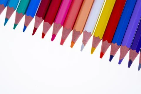 24 multicolored crayons on a white background, neatly arranged and sharpened. Foto stock