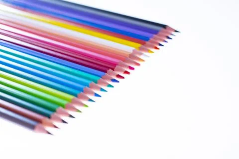 24 multicolored crayons on a white background, neatly arranged and sharpened. Foto stock