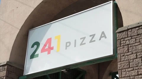 241 pizza restaurant store rectangle sign logo under arch arc in summer outside Stock Footage 250281003