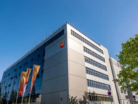 Building exterior of the pharmaceutical company GSK in Saxony. Modern industrial architecture and production hall of medical and consumer products. xkwx architecture brand british business company consumer goods dresden economy employer europe facility germany glaxosmithkline global gsk health care industry international label logo medicine modern nobody outdoors pharma pharmaceuticals place of work production hall saxony sign
