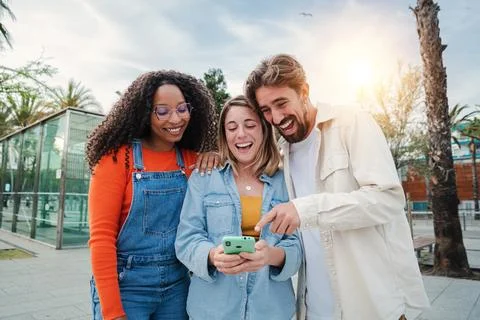 Group of multiracial friends having fun with a mobile phone watching funny videos on social media, play games, send messages. Three young happy people smiling and laughing using a callphone together. High quality photo xkwx group friend using mobile phone together smartphone smiling people enjoyment horizontal game watching happy diversity ethnicity generation laughing device multiracial online social relaxation connection meeting chat content friendship networking search showing teamwork looking funny sharing technology young phone smart mobile man woman trendy media browsing app message juvenile youth communication three