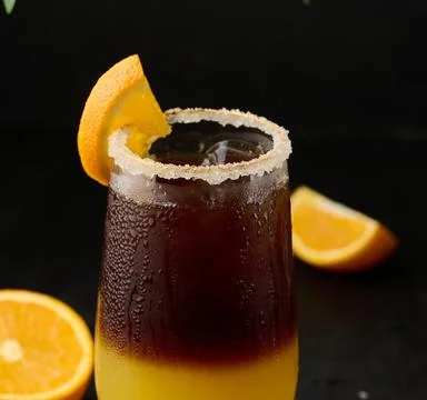 Iced coffee with orange juice in a transparent glass, refreshing bumble coffee on the table, black background xkwx coffee cold glass ice juice juicy layer morning nobody orange slice sweet syrup table yellow full beverage black brown bumble caffeine citrus cocktail cool drink espresso fresh fruit