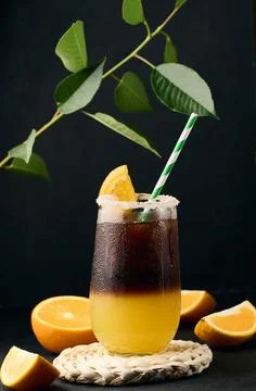 Iced coffee with orange juice in a transparent glass, refreshing bumble coffee on the table, black background xkwx layer coffee orange brown sweet cool ice espresso cold drink glass fresh juice beverage cocktail morning caffeine fruit syrup table yellow citrus juicy bumble slice nobody black