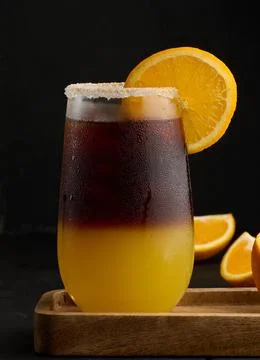Iced coffee with orange juice in a transparent glass, refreshing bumble coffee on the table, black background xkwx layer coffee orange brown sweet cool ice espresso cold drink glass fresh juice beverage cocktail morning caffeine fruit syrup table yellow citrus juicy bumble slice nobody black