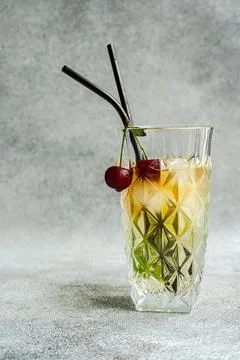 Glass of cold refreshing summer drink with cherry and rosemary sprig placed on gray surface against light background during summer celebration xkwx lemonade cocktail glass rosemary drink alcohol cherry beverage refreshment liquid natural celebrate delicious serve ice fresh cold tasty yummy flavor transparent berry cool ingredient thirst clean sour glassware appetizing aperitif fragrant aromatic infuse season decorate herb fruit water citrus liquor lemon slice delectable organic juice mint mix blurred background