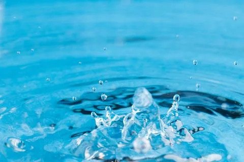 Close up of water drop falling into water with ripples and copy space on blue background. Water, liquid and colour concept. xkwx No People Close Water Drop Falling Water Ripple Copy Space Blue Background Liquid Colour Concept Drop Splash Abstract Design Background Wet Flow Fluid Closeup Wave Illustration Macro Business Graphic Symbol Isolated Flowing Color Clean Drink Water Falling Copy Space Blue