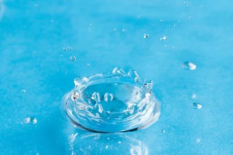 Close up of water drop falling into water with ripples and copy space on blue background. Water, liquid and colour concept. xkwx No People Close Water Drop Falling Water Ripple Copy Space Blue Background Liquid Colour Concept Drop Splash Abstract Design Background Wet Flow Fluid Closeup Wave Illustration Macro Business Graphic Symbol Isolated Flowing Color Clean Drink Water Falling Copy Space Blue