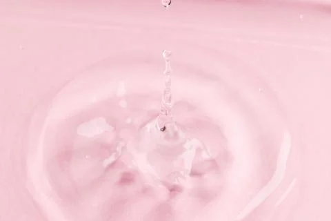Close up of water drop falling into water with ripples and copy space on pink background. Water, liquid and colour concept. xkwx No People Close Water Drop Falling Water Ripple Copy Space Pink Background Liquid Colour Concept Drop Splash Abstract Design Background Wet Flow Fluid Closeup Wave Illustration Macro Business Graphic Symbol Isolated Flowing Color Clean Drink Water Falling Copy Space Pink