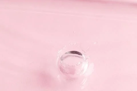 Close up of water drop falling into water with ripples and copy space on pink background. Water, liquid and colour concept. xkwx No People Close Water Drop Falling Water Ripple Copy Space Pink Background Liquid Colour Concept Drop Splash Abstract Design Background Wet Flow Fluid Closeup Wave Illustration Macro Business Graphic Symbol Isolated Flowing Color Clean Drink Water Falling Copy Space Pink