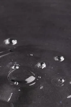 Close up of water drop falling into water with ripples and copy space on black background. Water, liquid and colour concept. xkwx No People Close Water Drop Falling Water Ripple Copy Space Black Background Liquid Colour Concept Drop Splash Abstract Design Background Wet Flow Fluid Closeup Illustration Wave Macro Business Graphic Symbol Flowing Isolated Color Drink Clean Water Falling Copy Space Black