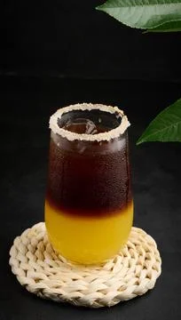 Iced coffee with orange juice in a transparent glass, refreshing bumble coffee on the table, black background xkwx layer coffee orange brown sweet cool ice espresso cold drink glass fresh juice beverage cocktail morning caffeine fruit syrup table yellow citrus juicy bumble slice nobody black