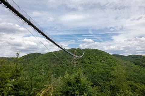 The Geierlay suspension bridge, the longest and most spectacular pedestrian bridge in Germany, near the village of Morsdorf in the Hunsruck region xkwx adventure blue bridge color image crossing europa forest geierlay geierlay bridge german germany green hanging hiking idyllic landscape moersdorf morsdorf mountain nature outdoor outdoors park path people pfalz rheinland rheinland-pfalz rhineland rhineland-palatinate scenics silk sky summer suspension suspension bridge tourism tourist trail travel tree trekking walk wood