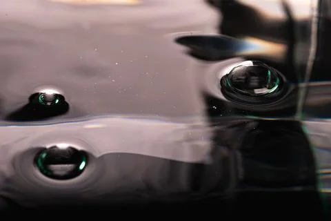 248.Three Glossy Bubbles on Reflective Dark Surface Stock Photos