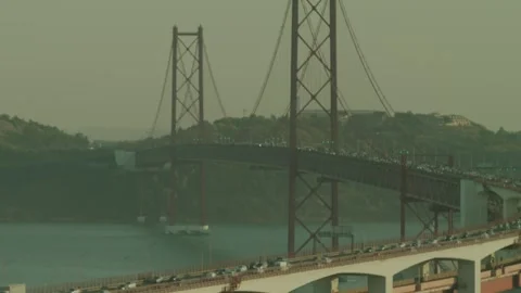 The 25 April Bridge (Ponte 25 De Abril) Located In Lisbon, Portugal, Crossi Stock Footage 273790559
