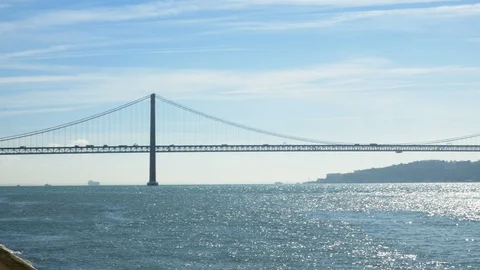 25 de Abril bridge in Lisbon, Portugal. A suspension bridge twin of the Golden Stock Footage 109378203