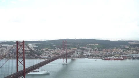 25 de Abril Bridge over the Tagus river, connecting Almada and Lisbon in Port Stock Footage 88734463