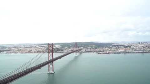 25 de Abril Bridge over the Tagus river, connecting Almada and Lisbon in Port Stock Footage 88734464
