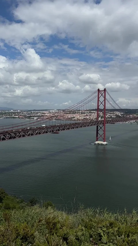 25 de Abril Bridge over Tagus River in Lisbon, Portugal, on cloudy day Stock Footage 346581828