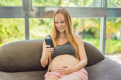 Mobile pregnancy online maternity application. Pregnant mother using phone. Pregnancy, medicine, pharmaceutics, health care and people concept. xkwx pregnant online pregnancy mother application woman app young technology maternity mobile cellphone phone internet beautiful belly expecting expectant home smartphone person abdomen connection motherhood communication anticipation sitting list expectance care mobile app expectation family photography buy blank concept information website cheerful programm copy space african american showing screen cell computer