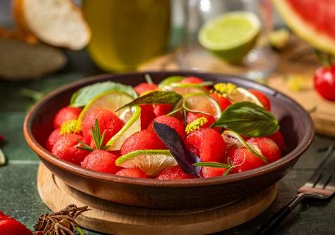 Spicy salad of fresh watermelon balls with basil, lime, rosemary and fennel, topping with olive oil on dark green table surface with sunny light xkwx watermelon vegetable summer food healthy salad basil lime rosemary freshness delicious cheese melon table organic epicure vegetarian plate fruit dinner meal sweet green diet red lunch fresh leaf juicy ripe snack herb closeup rustic overhead nourishment eating dish cookery