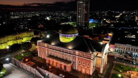 Colorful sunset sky over medieval building at cityscape downtown Manaus Brazil near Amazon river and Amazon Forest. Travel destinations. Sunset skyline. Sunset coastal city at Manaus Brazil. xkwx Colorful Sunset Manaus Amazonas Brazil europe modern architecture sidewalk famous landmark amazon historic skyscraper building museum church medieval theatre square theater dawn dusk evening sunrise sunset sky coast outdoor skyline light bright colorful illumination village city town travel tourism nature outdoors destinations river forest background landscape downtown urban district cityscape up above