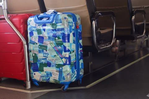 Passenger suitcases containing stickers are placed in the train cabin. Traveler who likes collecting stickers while traveling. Yogyakarta - Indonesia, 09 03 2023; xkwx tourism sticker object stickeres indoors ancient memo grunge symbol backgrounds airplane label car trunk hippie nostalgia stick stickers travelling aboard country travel shirt clothes retro leisure camera vacation tourist holiday concept baggage full clothing vintage background adventure voyage handle journey suitcase case luggage trip bag fashion accessory lifestyle business elegant human