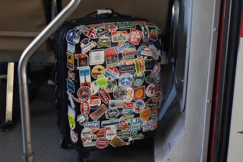 Passenger suitcases containing stickers are placed in the train cabin. Traveler who likes collecting stickers while traveling. Yogyakarta - Indonesia, 09 03 2023; xkwx tourism sticker object stickeres indoors ancient memo grunge symbol backgrounds airplane label car trunk hippie nostalgia stick stickers travelling aboard country travel shirt clothes retro leisure camera vacation tourist holiday concept baggage full clothing vintage background adventure voyage handle journey suitcase case luggage trip bag fashion accessory lifestyle business elegant human
