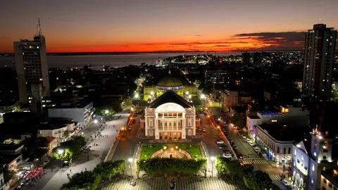 Colorful sunset sky over medieval building at cityscape downtown Manaus Brazil near Amazon river and Amazon Forest. Travel destinations. Sunset skyline. Sunset coastal city at Manaus Brazil. xkwx Colorful Sunset Manaus Amazonas Brazil europe modern architecture sidewalk famous landmark amazon historic skyscraper building museum church medieval theatre square theater dawn dusk evening sunrise sunset sky coast outdoor skyline light bright colorful illumination village city town travel tourism nature outdoors destinations river forest background landscape downtown urban district cityscape