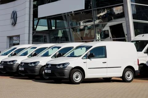 Minsk, Belarus, October 2023 - A row of white Volkswagen Caddy cars. German lorry auto xkwx auto automobile cargo commercial delivery drive freight front load logistic lorry motor post service shipping silver storage transport truck van vehicle warehouse bus distribution postal business industry modern new urban waiting car minivan road city outdoor park vw carrier express