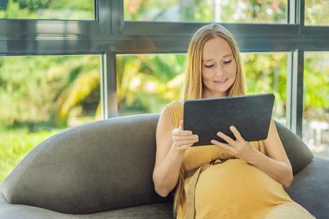 Mobile pregnancy online maternity application. Pregnant mother using phone. Pregnancy, medicine, pharmaceutics, health care and people concept. xkwx pregnant online pregnancy mother application woman app young technology maternity mobile cellphone phone internet beautiful belly expecting expectant home smartphone person abdomen connection motherhood communication anticipation sitting care morning bedroom smiling millennial tummy hand tablet programm african website photography template advertisement list blank reading concept indoors holding