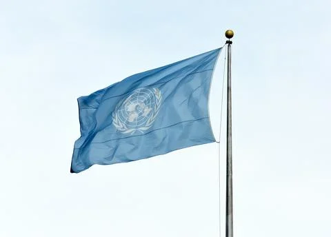 NEW YORK, USA - May 26, 2018: UN flag waving in the sky near the United Nations Building in New York. xkwx culture cloud wave sign symbol un united flag nations sky blue new york white nation building world national international government headquarters security city council country street breeze 42nd background establishing deep usa flags wind pole organizations clear