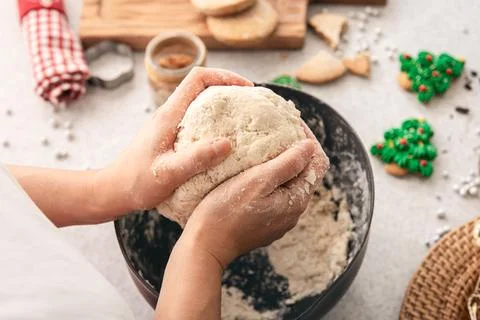 Hands knead thick dough on the kitchen table, decorated with festive decorations for Christmas and New year, baking at home. xkwx christmas food pastry dough homemade flour hand cooking gingerbread baking traditional kitchen table woman holiday xmas cookie sweet sugar bake cook home cake dessert biscuit delicious bowl celebration domestic person kneading lifestyle handmade fresh tasty recipe natural organic nutrition baked ingredient bakery chef dish preparation culinary festive