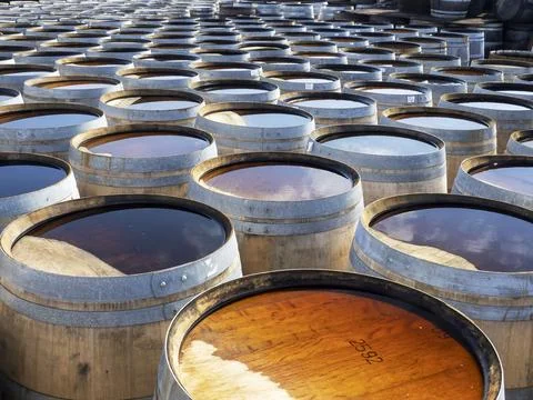 Whiskey barrels at the Ardbeg distillery in Ardbeg near Port Ellen on Islay, Inner Hebrides, Scotland, UK. xkwx Scotland coast island Hebrides Inner Hebrides Islay Isle of Islay Port Ellen whiskey distillery drink alcohol manufacturing building white Ardbeg barrel water