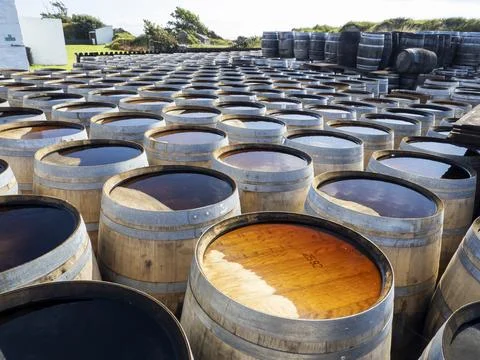 Whiskey barrels at the Ardbeg distillery in Ardbeg near Port Ellen on Islay, Inner Hebrides, Scotland, UK. xkwx Scotland coast island Hebrides Inner Hebrides Islay Isle of Islay Port Ellen whiskey distillery drink alcohol manufacturing building white Ardbeg barrel water